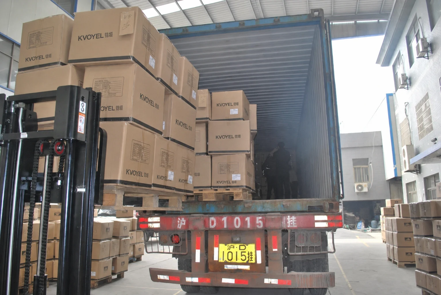 BOM-labelled export cartons being loaded for shipment